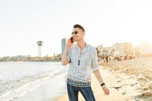 A man talking on the phone on the beach photo