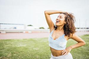 Girl with Latin features and happy, laughing afro hair. photo