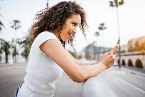 girl talking on a smartphone with surprise photo