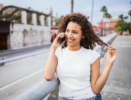 Latin girl talking on the smartphone. photo