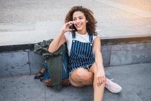 happy latina girl talking on a smartphone photo