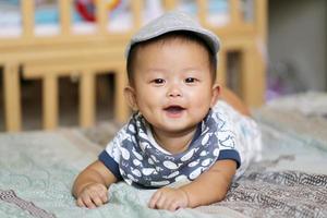 Asian baby lying on bed. photo