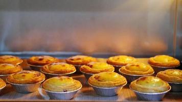 Egg tart making in the oven - famous dessert cooking footage video