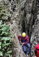 Young man descending by rappelling photo