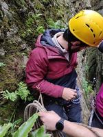 Young man descending by rappelling photo