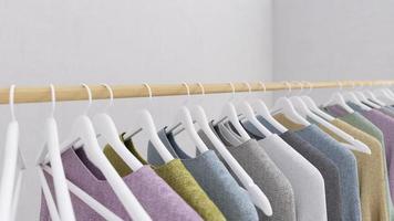 Clothes hanging on hanger with concrete wall background and copy space.3d rendering photo