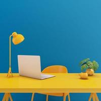 Table with laptop mock up.Yellow chair,lamp,table on blue background.Working space concept3d rendering photo