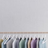 Clothes hanging on hanger with concrete wall background and copy space.3d rendering photo