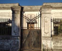 Old metal door and house, centered and balanced photo