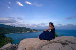 woman on the rock at sea view point photo