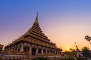golden ancient pagoda of Phra Mahathat Kaen Nakhon or Wat Nong Wang temple with twilight sunset sky photo