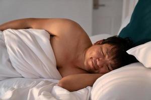 happy sleeping asian man photo