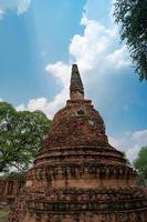 closeup broken and bending ancient pagoda or chedi ruins photo