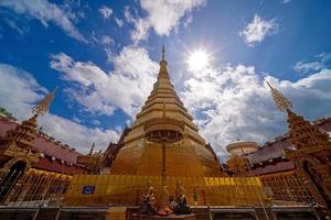 wide-angle view of golden pagoda at Wat Phra That Cho Hae Temple in Phrae photo
