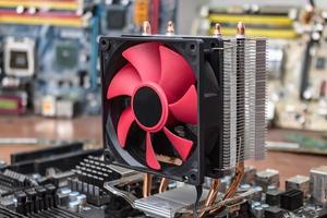 A broken motherboard cooling system due to dust is under repair in a computer workshop photo