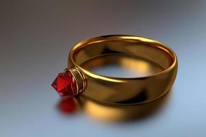 Golden ring with a red diamond on a reflective surface close-up photo