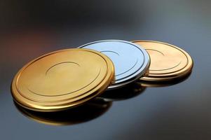 3D illustration with gold, silver and bronze discs on a reflective surface as a symbol of sports photo