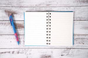 Notebook on wood table for background photo