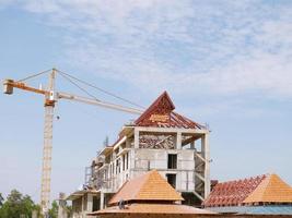 The building under construction overlooking the sky and clouds. photo