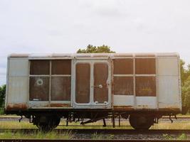 An abandoned, rusted, old train bogie overlooks the sky. photo