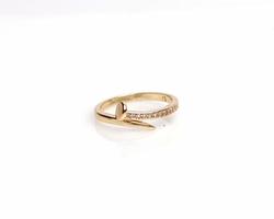 Jewelery ring with diamonds. Wedding rings that have deep meaning and significance. Engagement ring with gemstones. Wedding ring isolated on white background, focus blur. Pair in gold, silver, black. photo