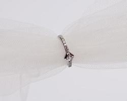 Concept photo of jewelry ring inserted in a roll of cloth. Wedding rings that have deep meaning and significance. Engagement ring with gemstones or diamonds. Wedding ring isolated on white background.