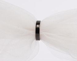Concept photo of jewelry ring inserted in a roll of cloth. Wedding rings that have deep meaning and significance. Engagement ring with gemstones or diamonds. Wedding ring isolated on white background.