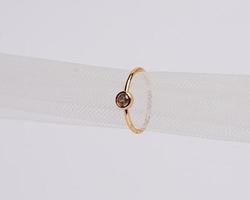 Concept photo of jewelry ring inserted in a roll of cloth. Wedding rings that have deep meaning and significance. Engagement ring with gemstones or diamonds. Wedding ring isolated on white background.