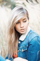 Close-up portrait of a beautiful woman in a denim jacket photo