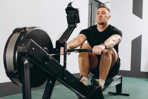 Man running rowing excercise in the gym photo