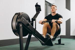 Man running rowing excercise in the gym photo