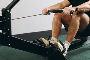 Man running rowing excercise in the gym photo