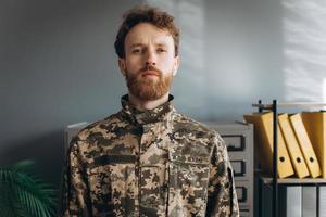 Ukrainian patriot soldier in military uniform in the office photo