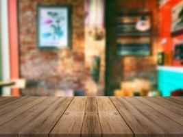 Wooden board empty table in front of blurred coffee shop background 2 photo