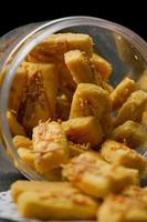 Crunchy kaastengels cookies. Dutch influenced Indonesian cookies, typically served during hari raya Eid Fitri. Selective focus image on black background photo