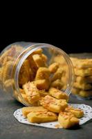 Crunchy kaastengels cookies. Dutch influenced Indonesian cookies, typically served during hari raya Eid Fitri. Selective focus image on black background photo