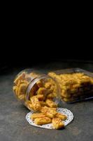 Crunchy kaastengels cookies. Dutch influenced Indonesian cookies, typically served during hari raya Eid Fitri. Selective focus image on black background photo