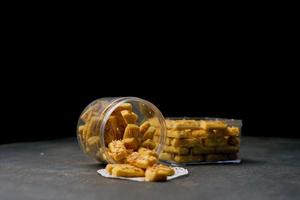 Crunchy kaastengels cookies. Dutch influenced Indonesian cookies, typically served during hari raya Eid Fitri. Selective focus image on black background photo