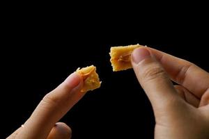 Crunchy kaastengels cookies. Dutch influenced Indonesian cookies, typically served during hari raya Eid Fitri. Selective focus image on black background photo