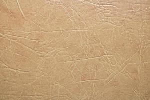 Light cream leather background. brown texture photo