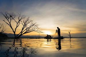 Fisherman of Bangpra Lake in action when fishing, Thailand. photo