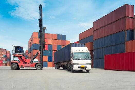Forklift handling container box loading to freight train in import and export photo