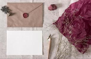 Mockup with envelope, wax seal, blank card and dry flowers. Styled photo. photo