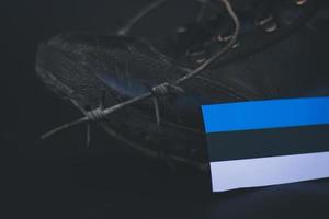 Estonia army, military boots flag Estonia and Barbed Wire, military concept photo