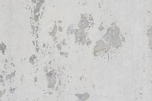 white white background and texture of peeling paint on plaster wall because  old paint expired. photo