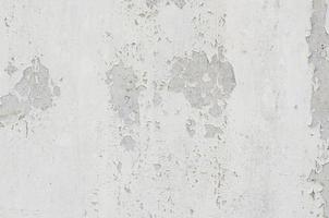 white white background and texture of peeling paint on plaster wall because  old paint expired. photo