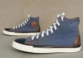 vintage style of sport blue sneaker shoe on gray background photo