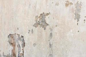 white white background and texture of peeling paint on plaster wall because  old paint expired. photo