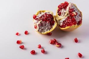 Dark red fruit pomegranate on white background copy space photo