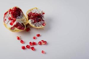 Dark red fruit pomegranate on white background copy space photo